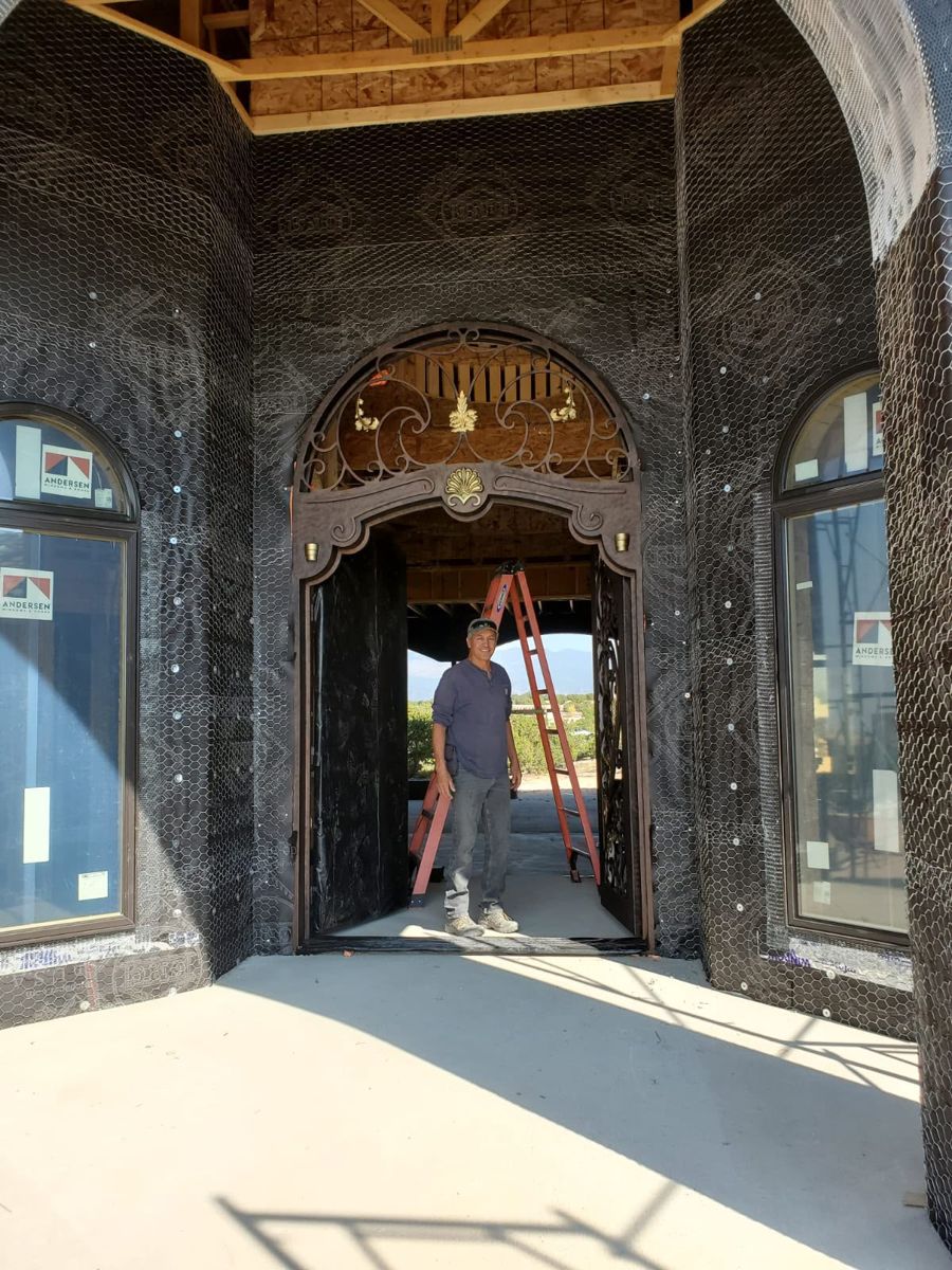Iron double door with arched transom installed in a new home in New Mexico
