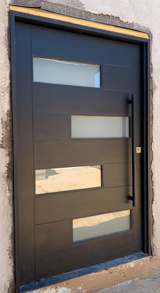 Modern black entry door with staggered glass panels and black pull bar