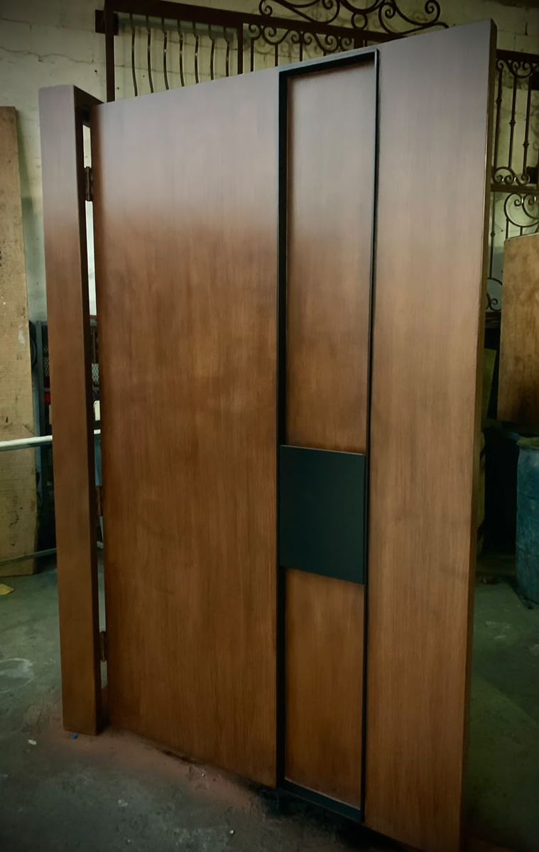 Oversized modern pivot door with inset black pull channel